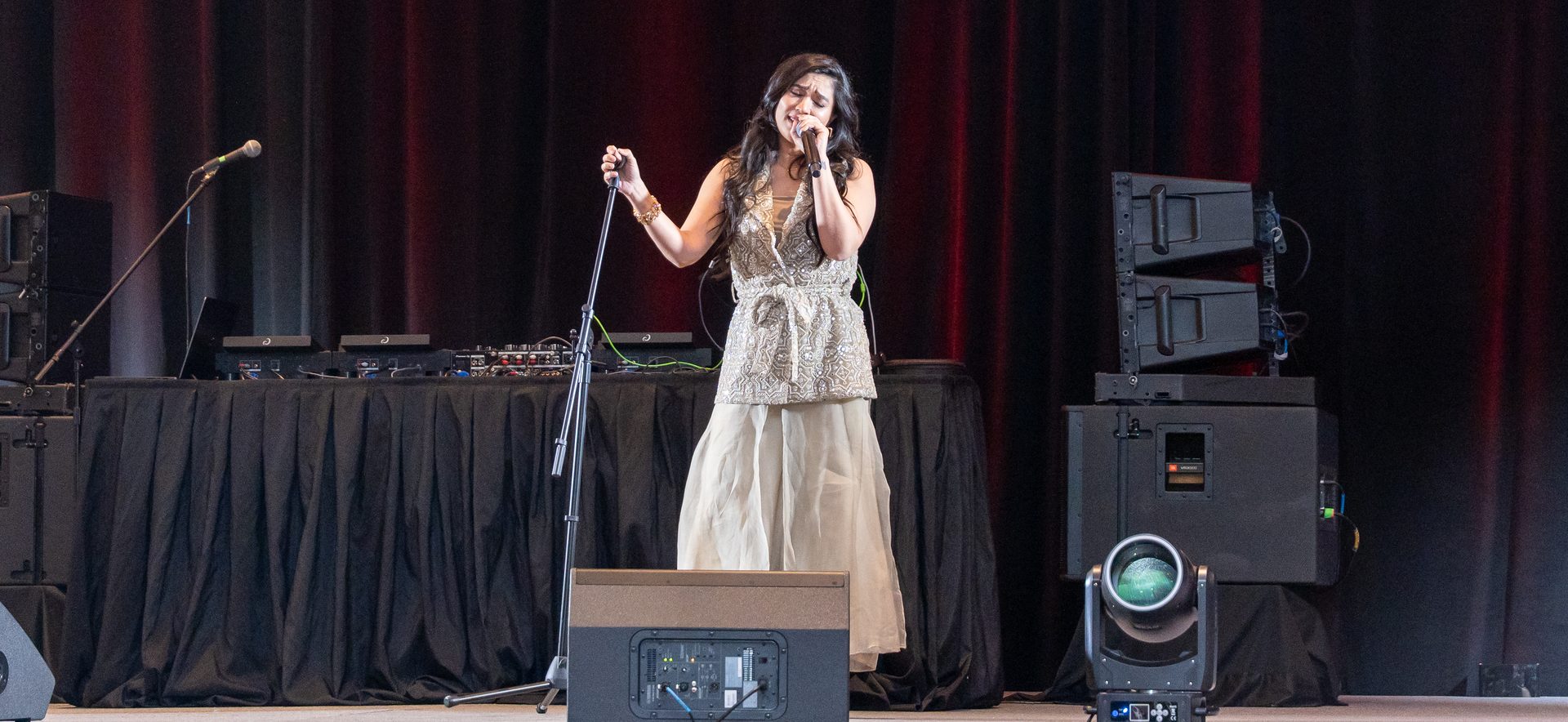 Live vocalist on stage with line array sound and moving head lighting at a 500 guest client appreciation gala produced by W Square