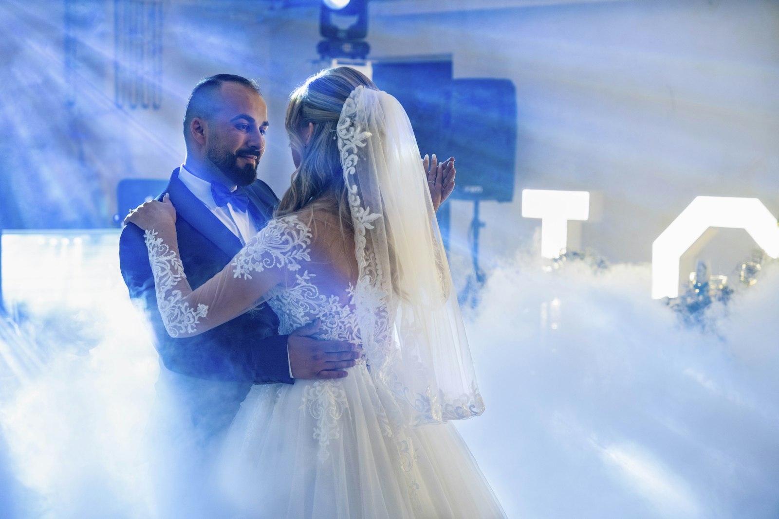 Couple first dance in a soft wash light with low fog