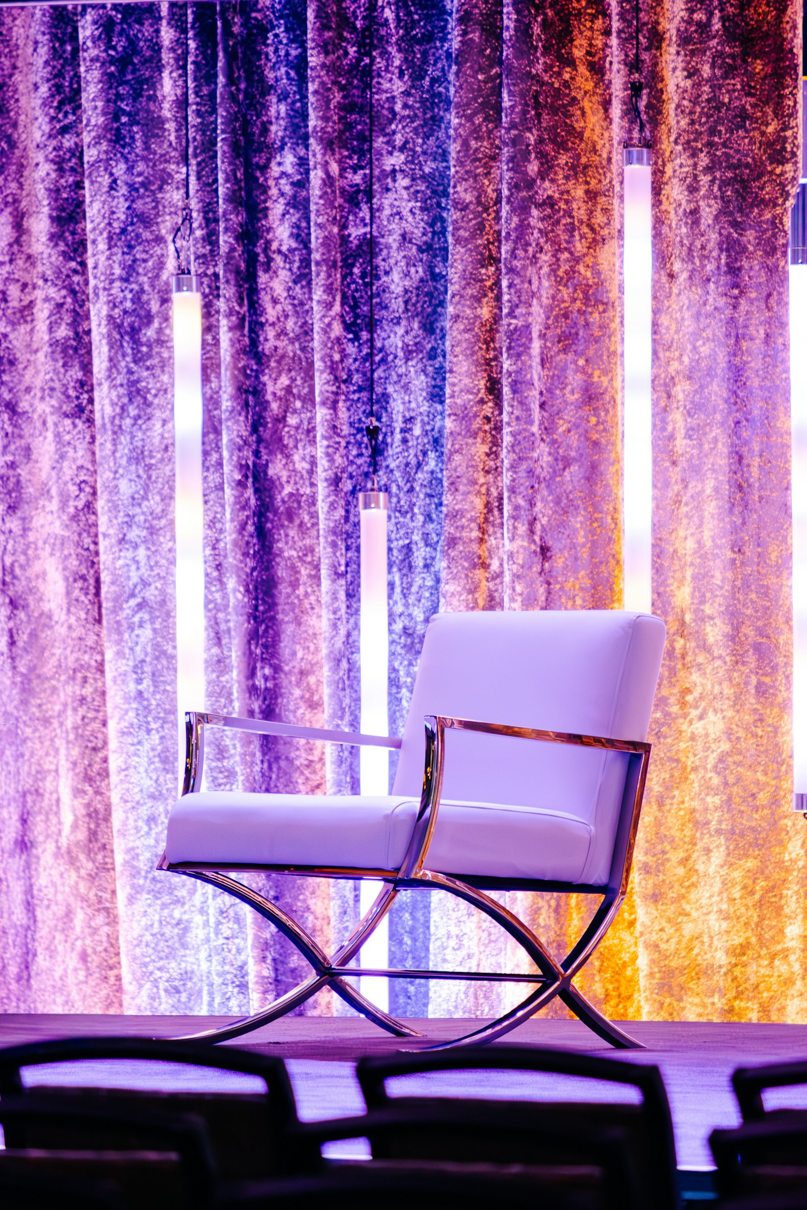 Drapes washed in purple and amber uplighting